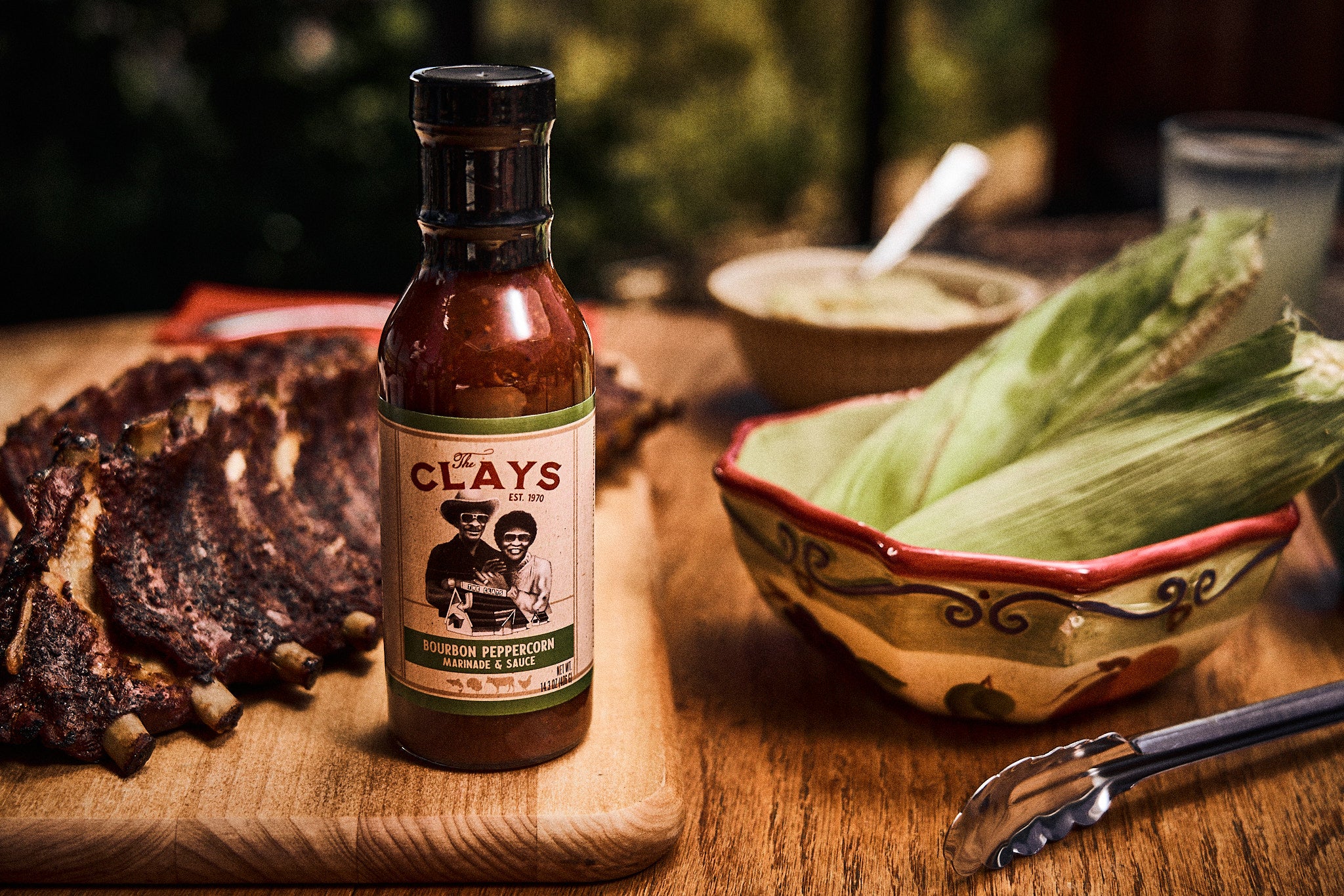 The Clay's Bourbon Infused Peppercorn Marindade With Food On Table